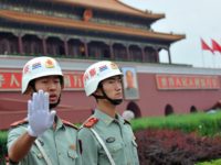 Chinese security personnel ask for no photos to be taken in front of Tiananmen Gate, near Tiananmen Square, one of China's most politically sensitive sites where the military crushed pro-democracy protests in 1989, in Beijing on August 17, 2008. A series of security measures have been implemented by Chinese authorities, …