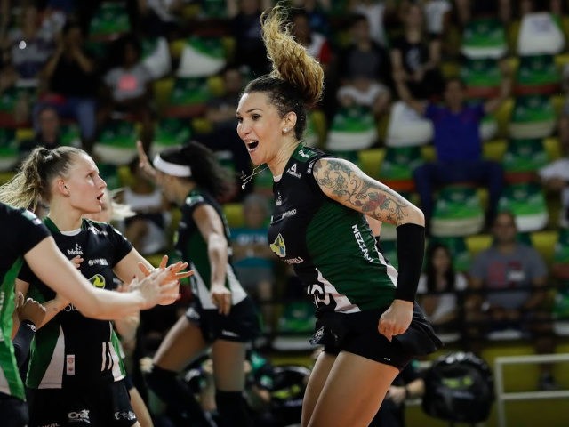 FILE - In this Tuesday, Dec. 19, 2017 file photo, Bauru's volleyball player Tiffany Abreu, right, celebrates with teammates during a Brazilian volleyball league match in Bauru, Brazil. Abreu became the first transgender player in the top women's volleyball league in 2017. Her record-setting performances have rankled Ana Paula Henkel, …