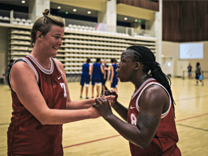 Ugandan transgender player Jay Mulucha (R) speaks with a teammate during the basketball competition at the 2018 Gay Games edition at the Palais des Sports Robert Charpentier in Issy- les-Moulineaux, south of Paris on August 7, 2018. - 32 year-old Jay plays with the Netherlands women's team, was expelled from …