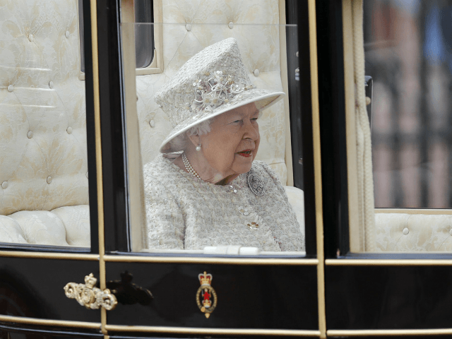 Britain's Queen Elizabeth rides in a carriage to attend the annual Trooping the Colour Cer