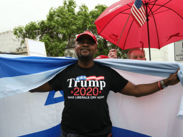 Trump supporters wave a US flag with one wrapped in an Israeli flag as they counter a demo