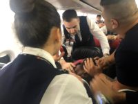 The scene as Associated Press photographer Hussein Malla observes as passengers and crew aboard a Turkish Airlines jetliner subdue a man who started screaming a few minutes after takeoff from Istanbul. Turkey, Friday June 14, 2019. The unidentified man began smashing at an oxygen mask box and damaged a cabin …