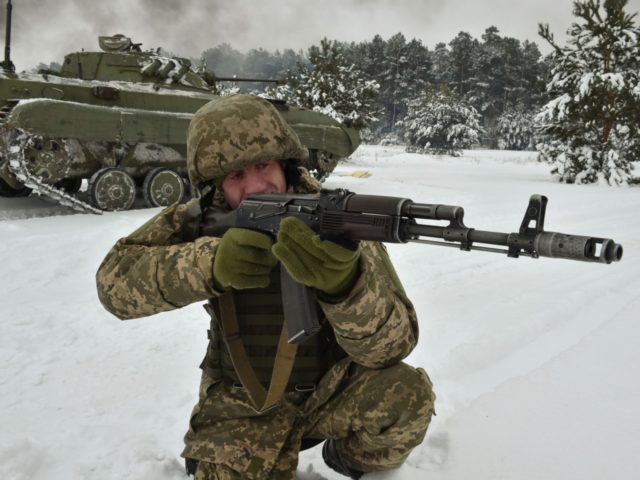 An Ukrainian army reservist aims at a target as he takes part in military exercises in the