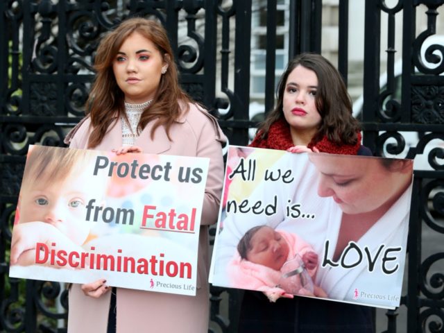 Pro-life, anti-abortion activists hold placards as they protest outside of Belfast High court in Belfast, on January 30, 2019, where Northern Ireland resident and campaigner Sarah Ewart, who after having been diagnosed with a fatal foetal abnormality in 2013 travelled to England for a termination, is a bringing a legal …