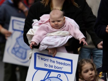 MELBOURNE, AUSTRALIA - JULY 28: A mother and her baby march during a protest on the steps of Parliment House on July 28, 2007 in Melbourne, Australia. The Labour government has attempted to decriminalise abortion, a move which may give medical professionals in Victoria the right not to perform abortions. …