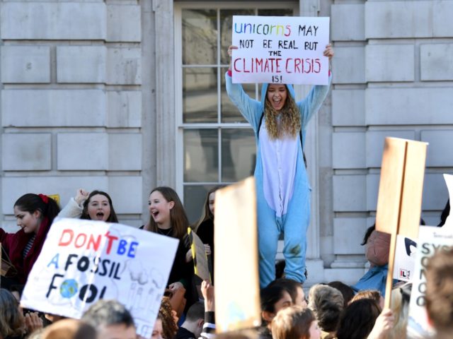 Young demonstrators hold placards as they attend a climate change protest organised by "Yo