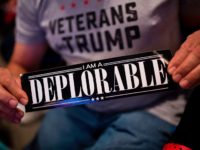 TOPSHOT - A supporter of Republican presidential candidate Donald Trump shows a bumper sticker reading "I am a Deplorable" at Mohegan Sun Arena in Wilkes-Barre, Pennsylvania on October 10, 2016. / AFP PHOTO / DOMINICK REUTER (Photo credit should read DOMINICK REUTER/AFP/Getty Images)
