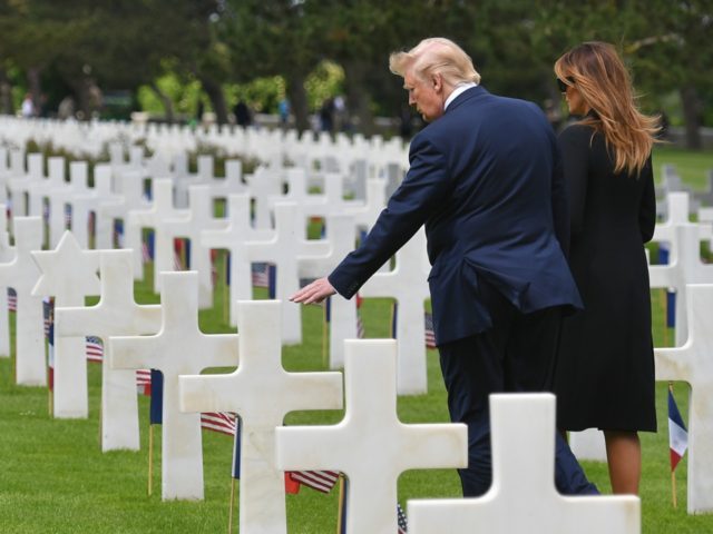 US President Donald Trump (L) and US First Lady Melania Trump (R) visit graves after a French-US ceremony at the Normandy American Cemetery and Memorial in Colleville-sur-Mer, Normandy, northwestern France, on June 6, 2019, as part of D-Day commemorations marking the 75th anniversary of the World War II Allied landings …