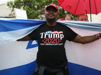 Trump supporters wave a US flag with one wrapped in an Israeli flag as they counter a demo