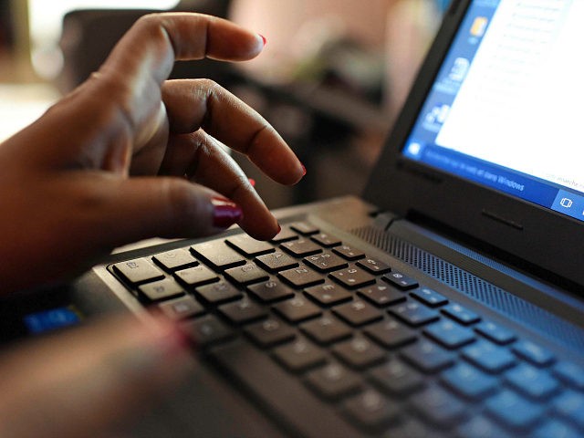 A woman uses a laptop on April 3, 2019, in Abidjan. - According to the figures of the plat