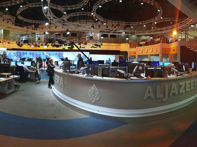 In this Thursday, June 8, 2017 photo, Al Jazeera staff work at their TV station in Doha, Q