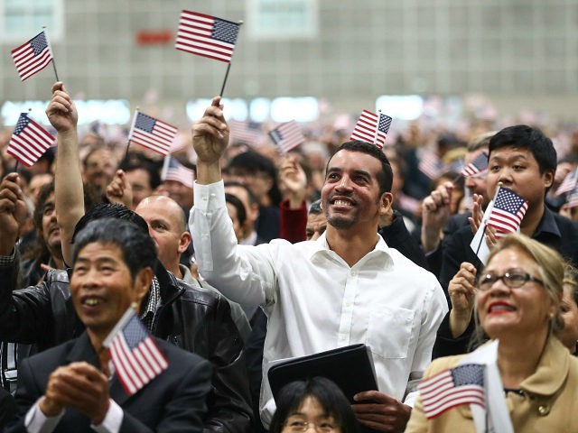 LOS ANGELES, CA - MARCH 20: New U.S. citizens wave American flags at a naturalization ceremony on March 20, 2018 in Los Angeles, California. The naturalization ceremony welcomed more than 7,200 immigrants from over 100 countries who took the citizenship oath and pledged allegiance to the American flag. During FY …