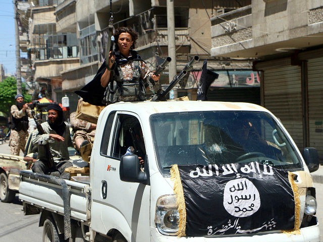 Fighters from Al-Qaeda's Syrian affiliate Al-Nusra Front drive in armed vehicles in the no