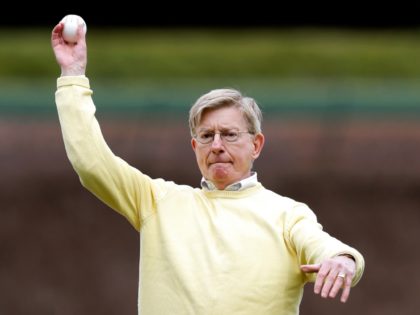 In this April 6, 2014 file photo, journalist and author George Will throws out the ceremonial first pitch before a baseball game between the Philadelphia Phillies and the Chicago Cubs in Chicago. The Chicago Cubs are trying to do something that hasn't happened in the lifetime of anyone born in …
