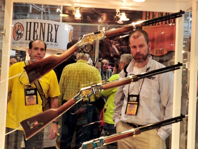 Convention attendees look at Henry rifles at the 2015 NRA Annual Convention in Nashville,