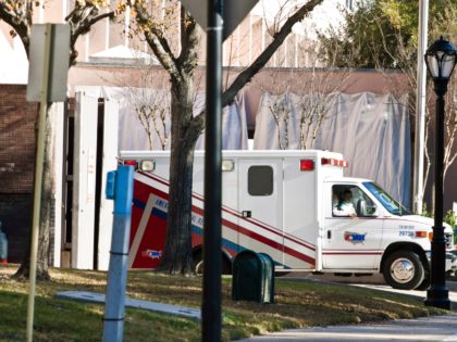 HOUSTON, TX - JANUARY 26: An ambulance, with husband Mark Kelly in the passenger seat, transfers U.S. Rep. Gabrielle Giffords (D-AZ) from the ICU at Memorial Hermann Hospital to the Texas Institute of Rehabilitation and Research (TIRR) to begin her long-term rehabilitation following a gunshot wound at close range to …