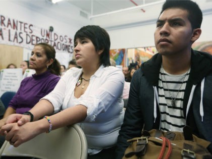 Undocumented immigrant Oscar Rodriguez (R), originally from Mexico, watches with Yenny Quispe (C), who is from Peru and received her Green Card two days ago, during a watch party of President Barack Obama's speech on immigration on January 29, 2013 in New York City. Obama called for immigration reform and …