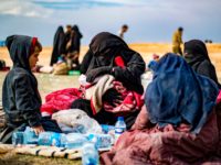 Dorothee Maquere, wife of French jihadist Jean-Michel Clain, sits with four of her five children at a screening area in the eastern Syrian province of Deir Ezzor, after fleeing the Islamic State (IS) group's embattled holdout of Baghouz, on March 5, 2019, during an operation by US-backed Syrian forces to …