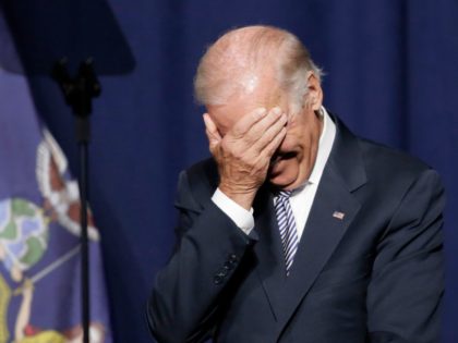 Vice President Joe Biden covers his face with his hand and New York Gov. Andrew Cuomo laughs as a speaker makes a comment about Republican presidential candidate Donald Trump, Thursday, Sept. 10, 2015, at a labor rally in New York. (AP Photo/Mark Lennihan)