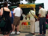 Racing fans gather around Alex's Lemonade Stand that benefits Pediatric Cancer Research before the start of the 137th Running of the Belmont Stakes at Belmont Park on June 11, 2005 in Elmont, New York. Alexandra "Alex" Scott was the 8 year old founder of Alex's Lemonade Stand. Two days before …