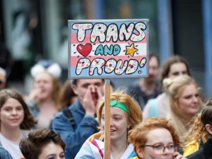 GLASGOW, SCOTLAND - AUGUST 19: A participant holds a sign saying "Trans and Proud" during the Glasgow Pride march on August 19, 2017 in Glasgow, Scotland. The largest festival of LGBTI celebration in Scotland has been held every year in Glasgow since 1996. (Photo by Robert Perry/Getty Images)