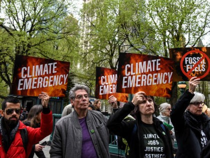 NEW YORK, NY - APRIL 17: People hold sign saying "climate emergency" while participating in a direct action with a protest group called Extinction Rebellion on April 17, 2019 in New York City. The activists are demanding governments declare a climate emergency to combat pollution. (Photo by Stephanie Keith/Getty Images)