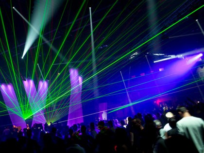 A laser show illuminates a hangar of the former Berlin airport Tempelhof during the Berlin Summer Rave 2012 in Berlin, Germany, early Sunday, July 22, 2012. Some 20.000 fans of electronic music are expected at the 3rd Berlin Summer Rave, a dance party in three hangars and on two extra …