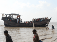 In this photograph taken on October 15, 2018, show people getting off a boat in Bhashan Char island off the Bangladeshi coast, as it was being prepared for the relocation of Rohingya refugees living in the country's south after fleeing violence in neighbouring Myanmar. - Dhaka has spent some $280 …