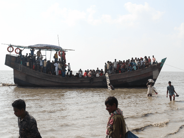 In this photograph taken on October 15, 2018, show people getting off a boat in Bhashan Ch