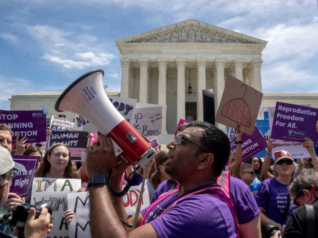 WASHINGTON, DC - MAY 21: Pro-choice protesters gather at the Supreme Court on May 21, 2019 in Washington, DC. The Alabama abortion law, signed by Gov. Kay Ivey last week, includes no exceptions for cases of rape and incest, outlawing all abortions except when necessary to prevent serious health problems …