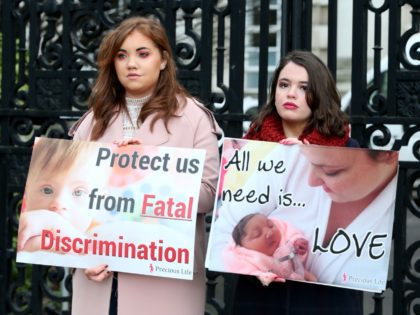 Pro-life, anti-abortion activists hold placards as they protest outside of Belfast High court in Belfast, on January 30, 2019, where Northern Ireland resident and campaigner Sarah Ewart, who after having been diagnosed with a fatal foetal abnormality in 2013 travelled to England for a termination, is a bringing a legal …