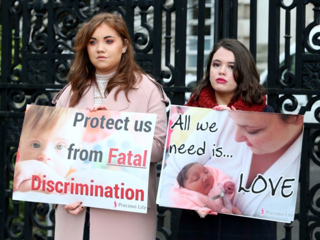 Pro-life, anti-abortion activists hold placards as they protest outside of Belfast High co