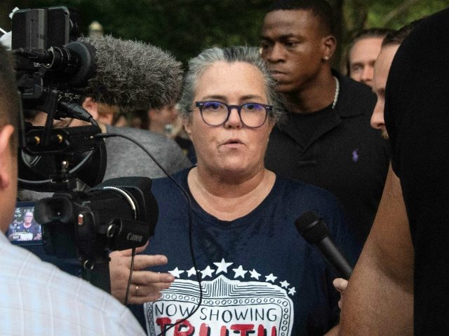 US comedian Rosie O'Donnell speaks to reporters as she leaves a protest against US Pr