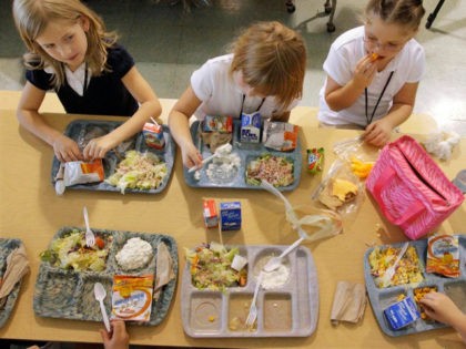In this Sept. 20, 2011 photo, students eat their lunch at Northeast Elementary Magnet in Danville, Ill. The curriculum at the public school is focused on health and wellness, and families have to sign a contract agreeing to abide by that. School lunches are low-fat or no-fat, with fresh fruit …