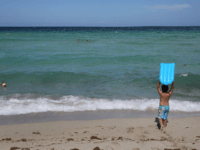 Mateo Saez prepares to enter the ocean water off of Haulover Beach where a rare shark attack occured on Sunday afternoon on July 11, 2017 in Sunny Isles, Florida. Miami-Dade Fire Rescue officials said they believe the person bitten, Elvin Lanza, was bitten by a 4- to 5-foot bull shark. …