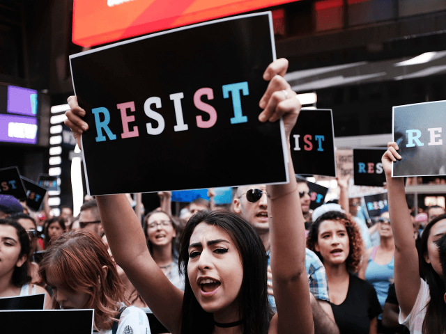 NEW YORK, NY - JULY 26: Dozens of protesters gather in Times Square near a military recruitment center to show their anger at President Donald Trump's decision to reinstate a ban on transgender individuals from serving in the military on July 26, 2017 in New York City. Trump citied the …