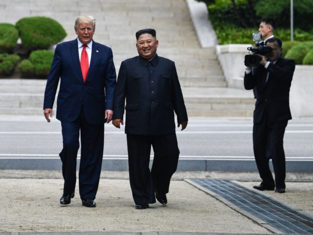 North Korea's leader Kim Jong Un walks with US President Donald Trump north of the Military Demarcation Line that divides North and South Korea, in the Joint Security Area (JSA) of Panmunjom in the Demilitarized zone (DMZ) on June 30, 2019. (Photo by Brendan Smialowski / AFP) (Photo credit should …