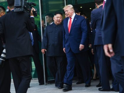 North Korea's leader Kim Jong Un (centre L) and US President Donald Trump walk following a
