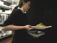 MAY 05: A waitress at Osha Thai Restaurant carries plates of food along with bowls of jasmine rice May 5, 2008 in San Francisco, California. As rice prices continue to climb and some places are limiting the number of bags small businesses can purchase, many Bay Area restaurants are being …