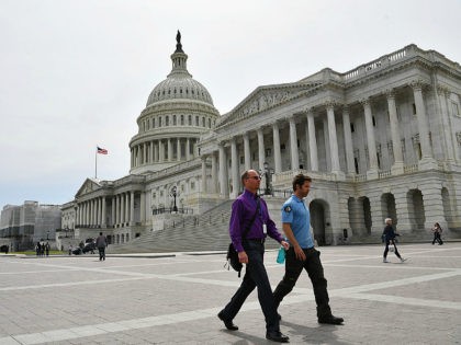 Men walk past the US Capitol in Washington, DC, on April 17, 2019. (Photo by MANDEL NGAN / AFP) (Photo credit should read MANDEL NGAN/AFP/Getty Images)