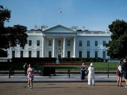People walk on Pennsylvania Avenue outside the White House on June 18, 2018 in Washington,