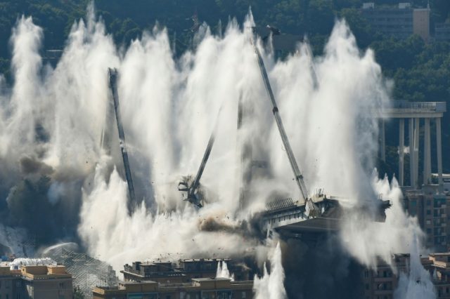 The remains of the 4,500-tonne bridge collapsed in seconds as officials and locals watched the demolition from a distance Italy demolishes remains of Genoa bridge