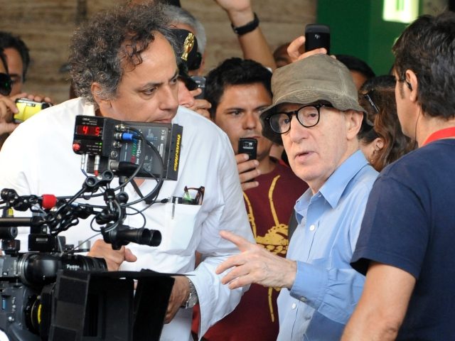 US film director Woody Allen (C) chats with his team on the set of his new film The Bop De