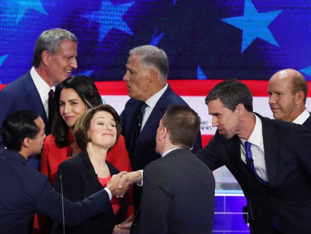 MIAMI, FLORIDA - JUNE 26: Chuck Todd of NBC News greets Sen. Amy Klobuchar (D-MN), former housing secretary Julian Castro, former Texas congressman Beto O'Rourke and other candidates after the first night of the Democratic presidential debate on June 26, 2019 in Miami, Florida. A field of 20 Democratic presidential …