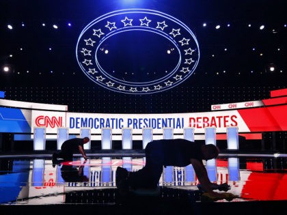 Workers get the stage ready for the Democratic presidential primary debate, Tuesday, July