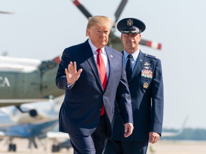 President Donald J. Trump, joined by U.S. Air Force Col. Samuel Chesnut, waves to the pres