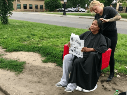 Hair stylist carries her red salon chair to the homeless