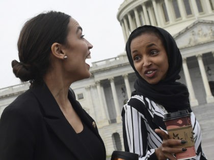 Rep. Alexandria Ocasio-Cortez, D-N.Y., left, talks with Rep. Ilhan Omar, D-Minn., center,