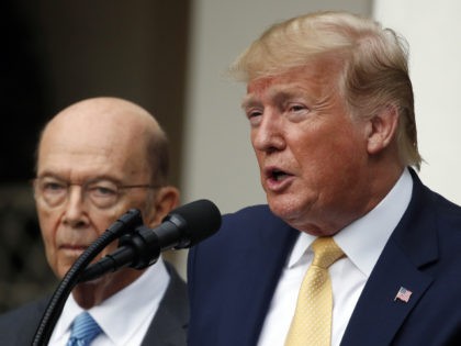 President Donald Trump is joined by Commerce Secretary Wilbur Ross as he speaks in the Rose Garden at the White House in Washington, Thursday, July 11, 2019. (AP Photo/Alex Brandon)