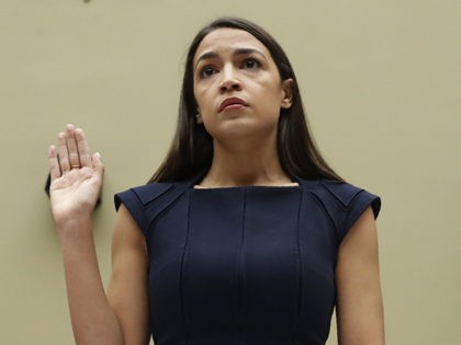 Rep. Alexandria Ocasio-Cortez, D-NY., stands to be sworn in before she testifies before the House Oversight Committee hearing on family separation and detention centers, Friday, July 12, 2019 on Capitol Hill in Washington. Rep. Veronica Escobar, D-Texas, is left and Rep. Rashida Tlaib, D-Mich., right. (AP Photo/Pablo Martinez Monsivais)